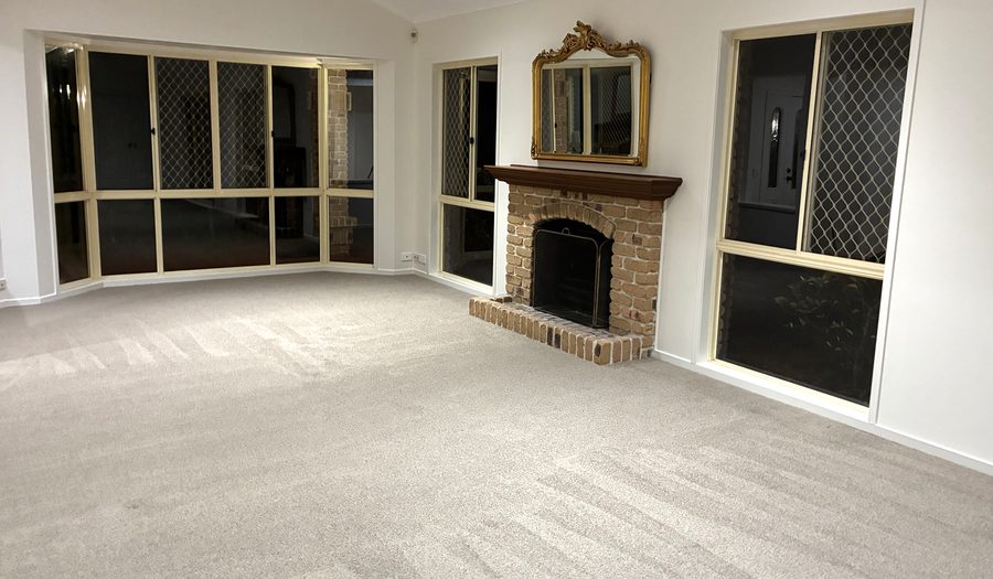 Empty living room with freshly vacuumed carpet after an end of lease clean, Brisbane